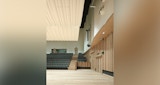 Rehearsal space for Queensland Symphony Orchestra. interior clad with timber floor, wall paneling and seating inside the KIRK studio designed ABC Headquarters building in Southbank, Australia.