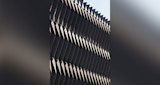 Close-up of ABC Headquarters' exterior metal cladding. Geometric repeating pattern in full sun.