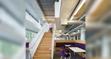 Internal lobby view of stairwell with timber detail and open meeting spaces, inside the KIRK studio designed ABC Headquarters building in Southbank, Australia.