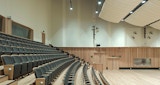 Symphony orchestra performance space auditorium stacked seating view inside the Symphony Orchestra rehearsal space, designed by KIRK studio for the ABC Headquarters building in Southbank, Australia. Down lighting and acoustic ceiling barriers. Timber accents, steps and floors.