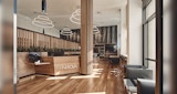 entry lobby inside NIOA Melbourne Fit out, Interior Architecture by Kirk Studio. with built-in timber reception desk with large timber batten clad support pillars. Black leather chairs.