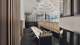 double height ceiling in open concept office space with ring lighting inside commercial office building - NIOA Melbourne Fit out, Interior Architecture by Kirk Studio., black carpet, communal desks and timber partitions.
