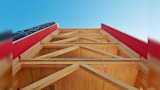 Construction view looking up from ground of Mass engineered timber commercial building. Timber support beams.