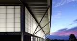Exterior features at dusk on the exterior of the Aboriginal and Islander Independent Community School (AIICS) Hall.