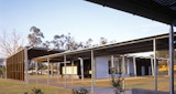 Exterior grounds of the completed Aboriginal and Islander Independent Community School (AIICS) designed by KIRK studio, with covered pedestrian pathways.