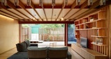 Interior ground level of living space inside KIRK studio designed West End House, Australia. Timber floors, walls and accents line the interior.