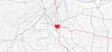 A linework based map of Brisbane showing major transport networks in red converging at the woolloongabba site - represented by a heart.