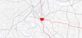 A linework based map of Brisbane showing major transport networks in red converging at the woolloongabba site - represented by a heart.